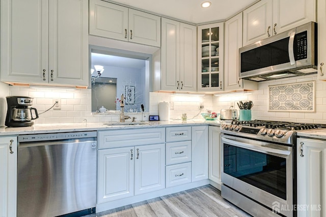 16 Jeanette Ct Unit 293, Jamesburg, NJ 08831 - kitchen with appliances with stainless steel finishes, glass insert cabinets, tasteful backsplash, light wood finished floors, and recessed lighting