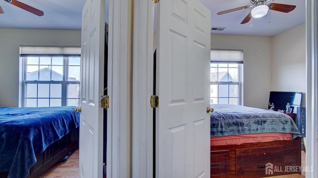 bedroom with wood-type flooring and ceiling fan