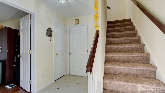 staircase featuring tile patterned floors