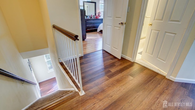 stairway with hardwood / wood-style floors