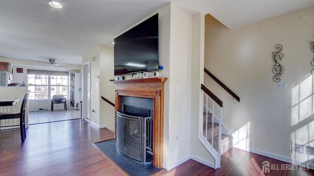 living room with hardwood / wood-style floors and ceiling fan