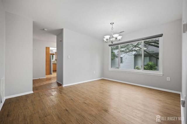 70 Lexington Cir, Old Bridge, NJ 07747 - spare room featuring a chandelier and wood finished floors