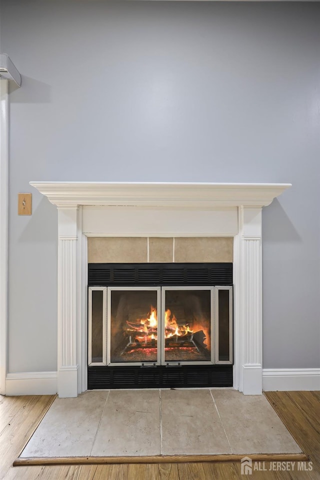 70 Lexington Cir, Old Bridge, NJ 07747 - detailed view of a fireplace with flush hearth and wood finished floors