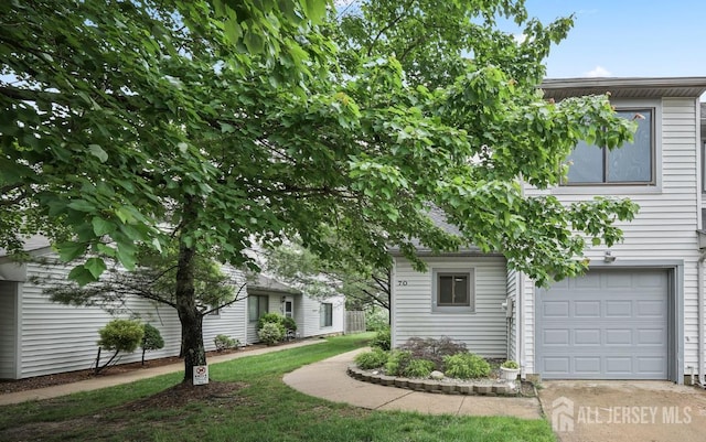 70 Lexington Cir, Old Bridge, NJ 07747 - view of property hidden behind natural elements with an attached garage and concrete driveway
