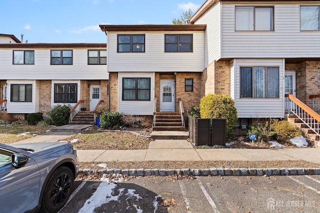 3 Wood Acres Dr, North Brunswick, NJ 08902 - townhome / multi-family property featuring brick siding, uncovered parking, and entry steps