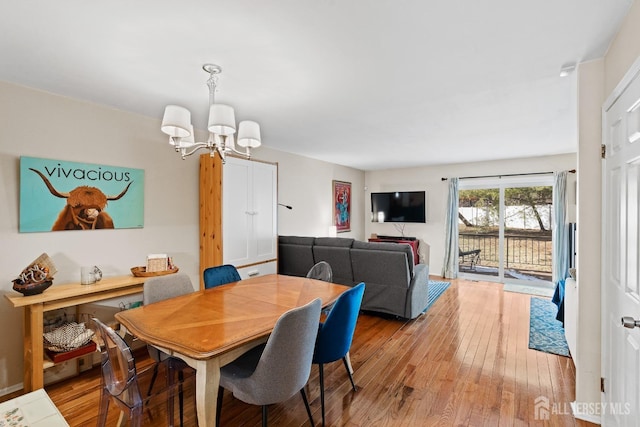 dining space featuring a chandelier and light wood-type flooring