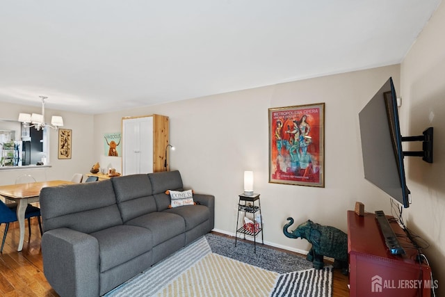 living room featuring hardwood / wood-style flooring and a notable chandelier