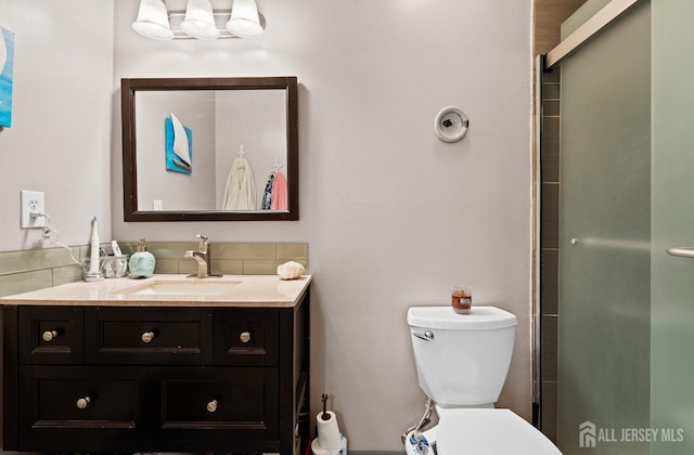 bathroom with vanity, toilet, and an enclosed shower