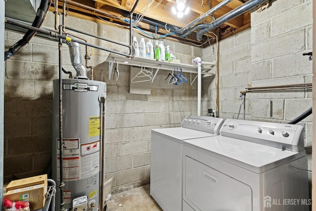 laundry area with gas water heater and separate washer and dryer