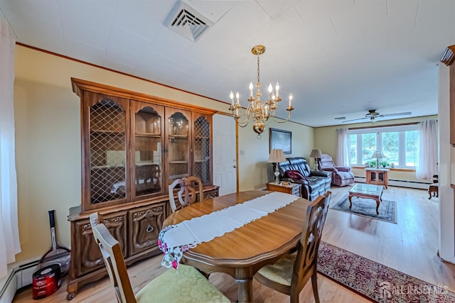 dining room featuring light hardwood / wood-style floors, baseboard heating, crown molding, and ceiling fan with notable chandelier