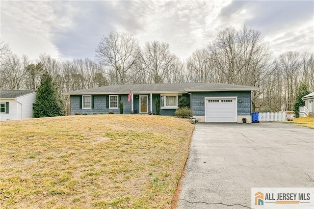 ranch-style house featuring aphalt driveway, an attached garage, a front yard, and fence