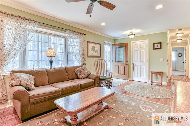 living room featuring recessed lighting, baseboards, wood finished floors, and ornamental molding