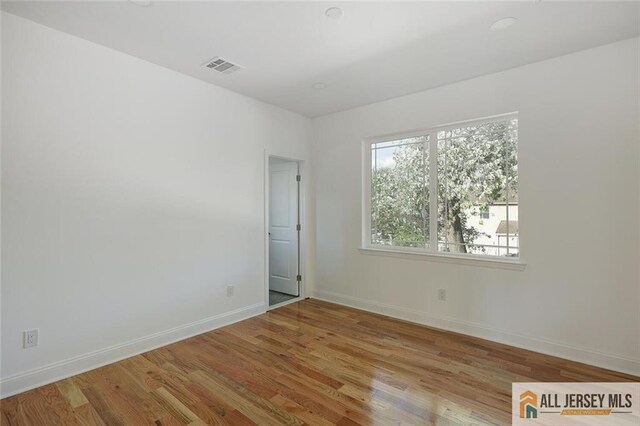 unfurnished room with light wood-type flooring