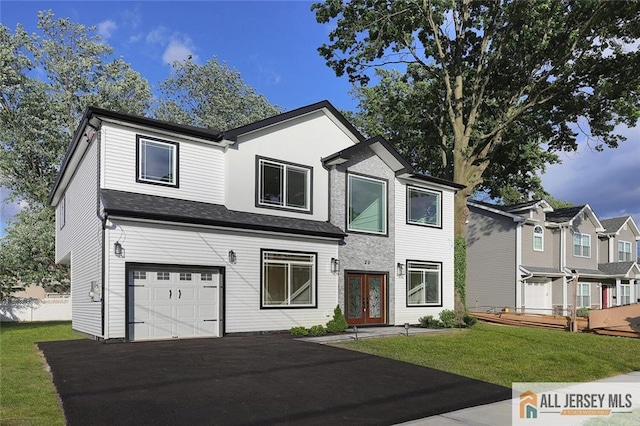 view of front of home featuring a garage, a front yard, and french doors