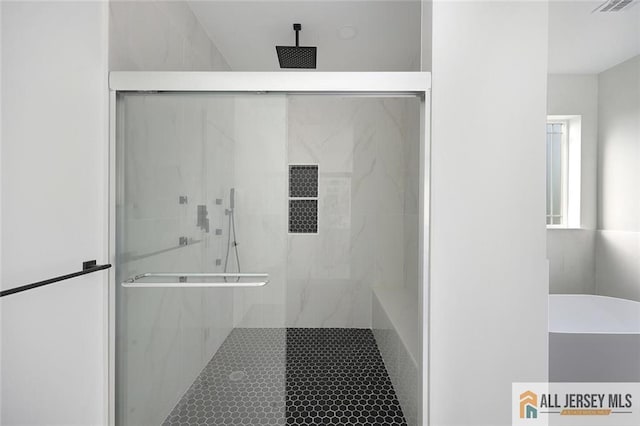 bathroom featuring a shower with shower door