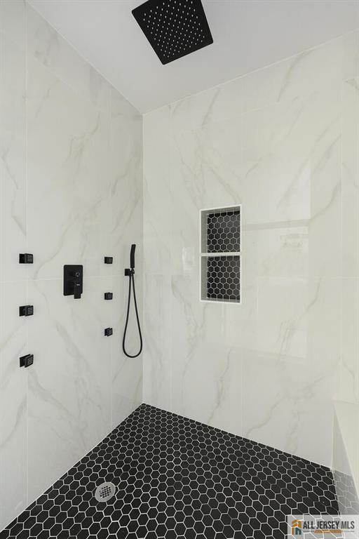 bathroom with tiled shower