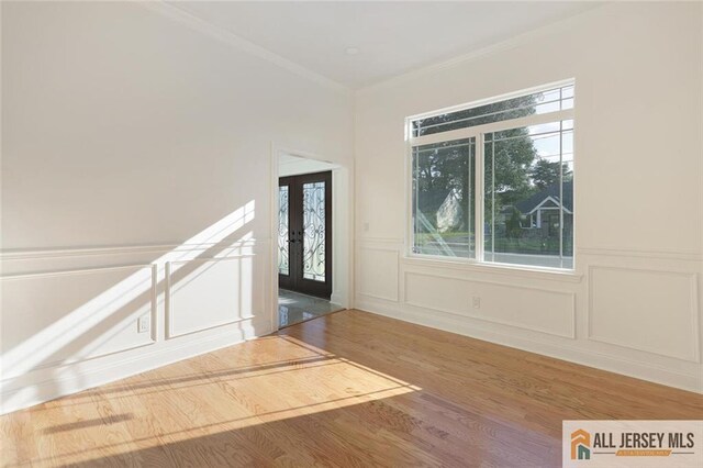 entryway featuring hardwood / wood-style floors and ornamental molding