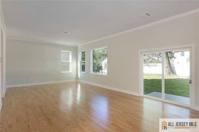 empty room with visible vents, plenty of natural light, and light wood-style flooring