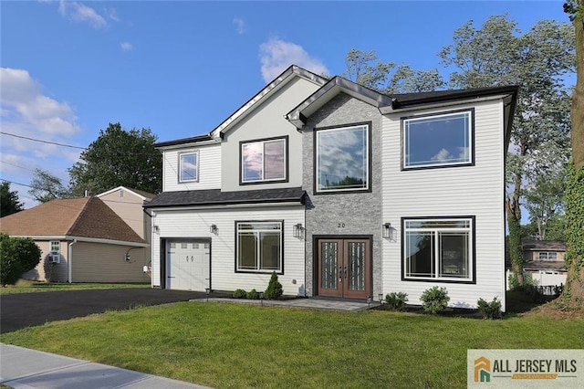 view of front of home with french doors, a garage, and a front lawn