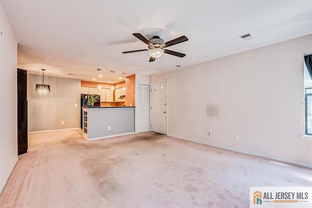 331 Cozzens Ct Unit 331, East Brunswick, NJ 08816 - unfurnished living room featuring light colored carpet, a chandelier, a ceiling fan, and recessed lighting