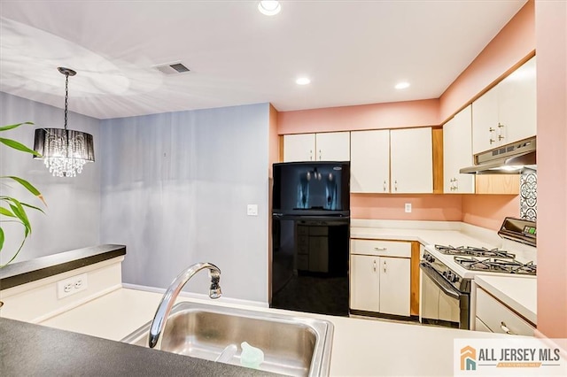 331 Cozzens Ct Unit 331, East Brunswick, NJ 08816 - kitchen featuring freestanding refrigerator, under cabinet range hood, white range with gas cooktop, a chandelier, and hanging light fixtures