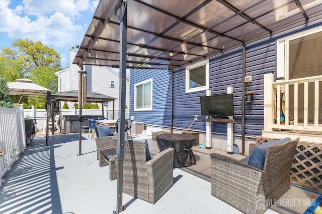view of patio / terrace with fence, an outdoor living space, a gazebo, central air condition unit, and outdoor dining space