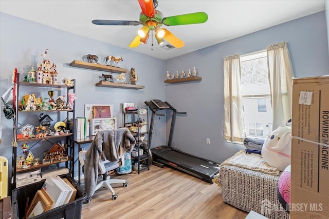 office space featuring visible vents, a ceiling fan, and wood finished floors