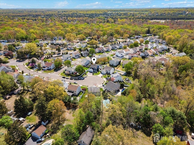 drone / aerial view featuring a forest view and a residential view