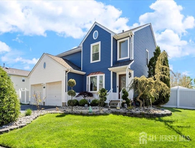 traditional-style home featuring fence, an attached garage, driveway, and a front lawn