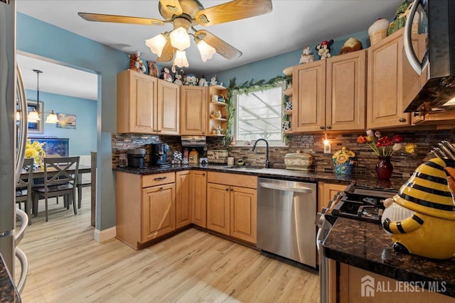kitchen with backsplash, appliances with stainless steel finishes, open shelves, a sink, and light wood-style flooring
