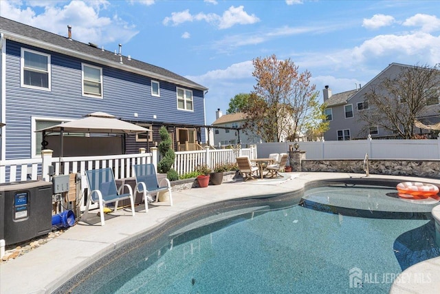 view of swimming pool featuring a fenced in pool, fence, a patio, and a gazebo