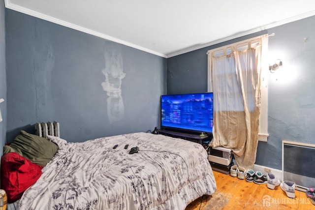 bedroom featuring crown molding and wood-type flooring