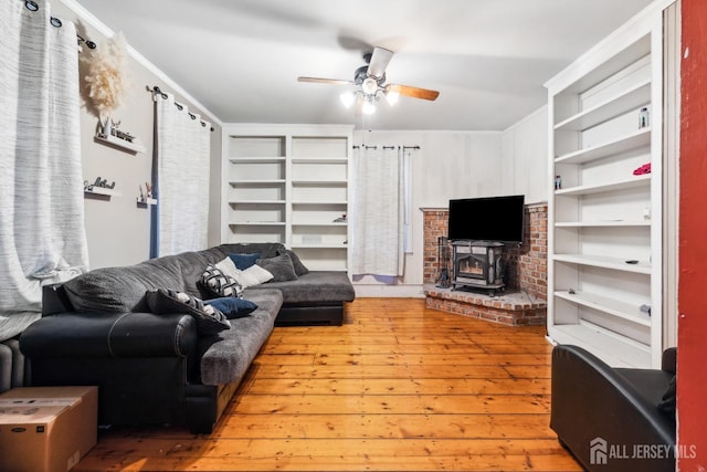 living room with crown molding, ceiling fan, and light hardwood / wood-style floors