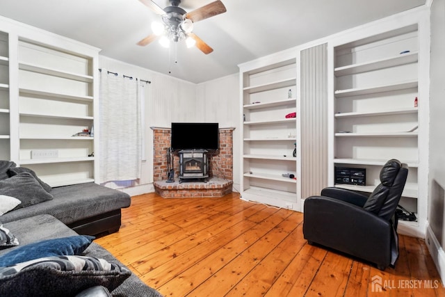 living room with ceiling fan and hardwood / wood-style floors