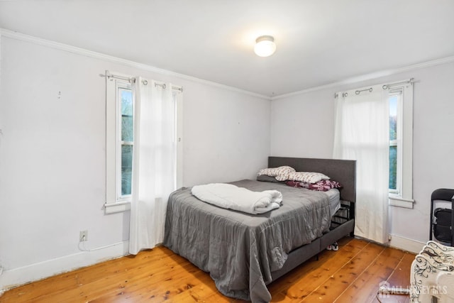 bedroom featuring crown molding and hardwood / wood-style flooring