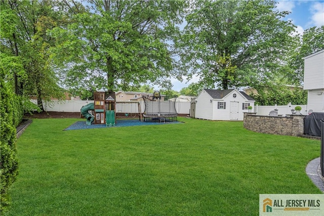 10 Buttonwood Dr, Old Bridge, NJ 08857 - view of yard with a trampoline, a playground, and an outdoor structure