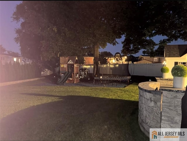 10 Buttonwood Dr, Old Bridge, NJ 08857 - yard at night featuring a playground