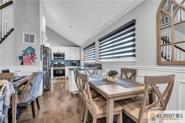 10 Buttonwood Dr, Old Bridge, NJ 08857 - dining room with vaulted ceiling, wood finished floors, and wainscoting