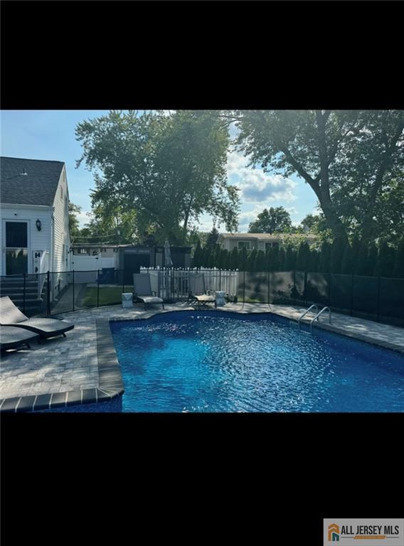 10 Buttonwood Dr, Old Bridge, NJ 08857 - view of pool with a patio area