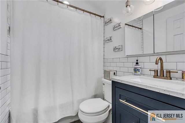 10 Buttonwood Dr, Old Bridge, NJ 08857 - bathroom featuring toilet, tile walls, backsplash, and vanity