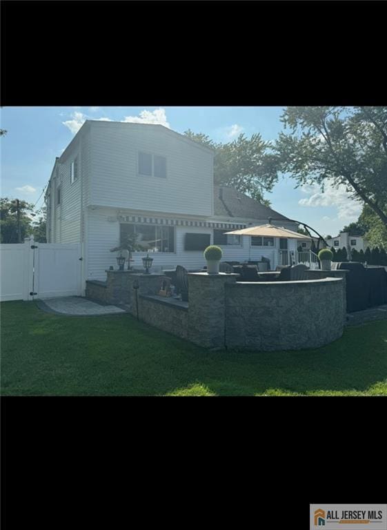 10 Buttonwood Dr, Old Bridge, NJ 08857 - rear view of house featuring a gate