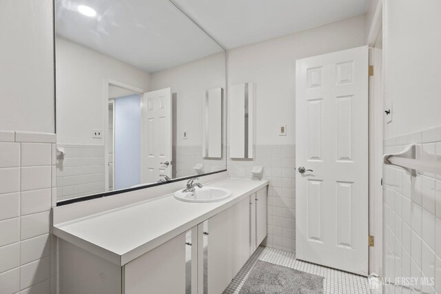 bathroom with vanity, tile walls, and tile patterned floors