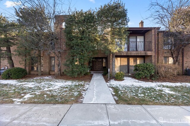 view of property with a balcony and central AC unit