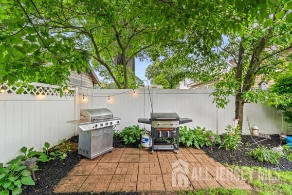 185 Rowland Pl, Woodbridge Proper, NJ 07095 - fenced backyard featuring grilling area and a patio area