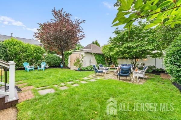 185 Rowland Pl, Woodbridge Proper, NJ 07095 - fenced backyard featuring a patio and an outbuilding