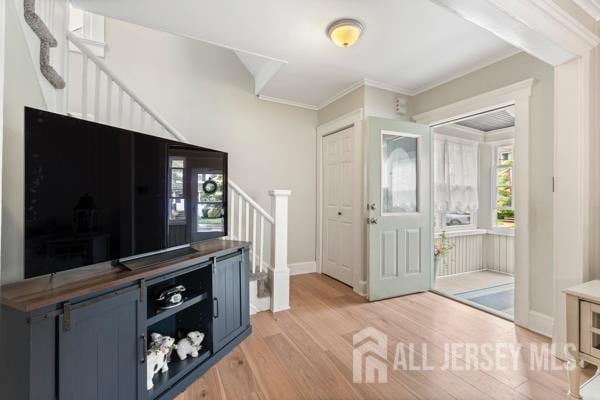 185 Rowland Pl, Woodbridge Proper, NJ 07095 - foyer entrance featuring stairs, light wood-style floors, and crown molding