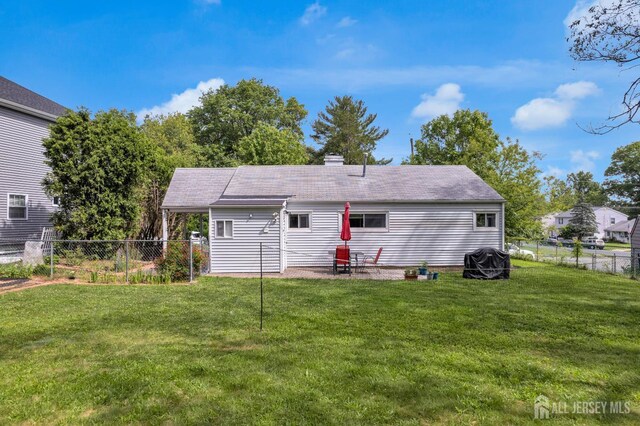 4 Dayton Rd, Edison, NJ 08817 - back of property with a fenced backyard, a chimney, roof with shingles, and a patio