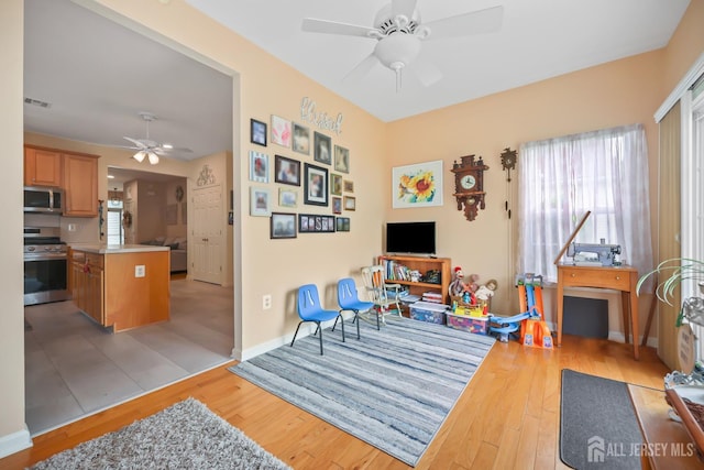 4 Holly Manor Ct, Helmetta, NJ 08828 - living area with ceiling fan, light wood-style floors, and healthy amount of natural light