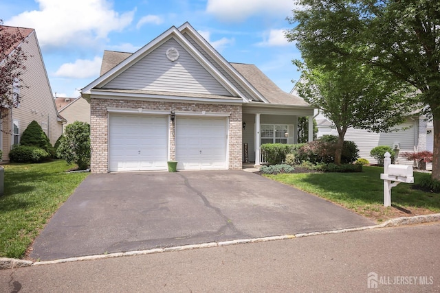 4 Holly Manor Ct, Helmetta, NJ 08828 - view of front of home featuring brick siding, asphalt driveway, an attached garage, a front yard, and roof with shingles