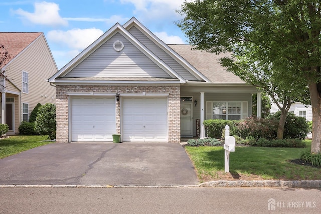 4 Holly Manor Ct, Helmetta, NJ 08828 - view of front of home featuring an attached garage, brick siding, driveway, and a front yard
